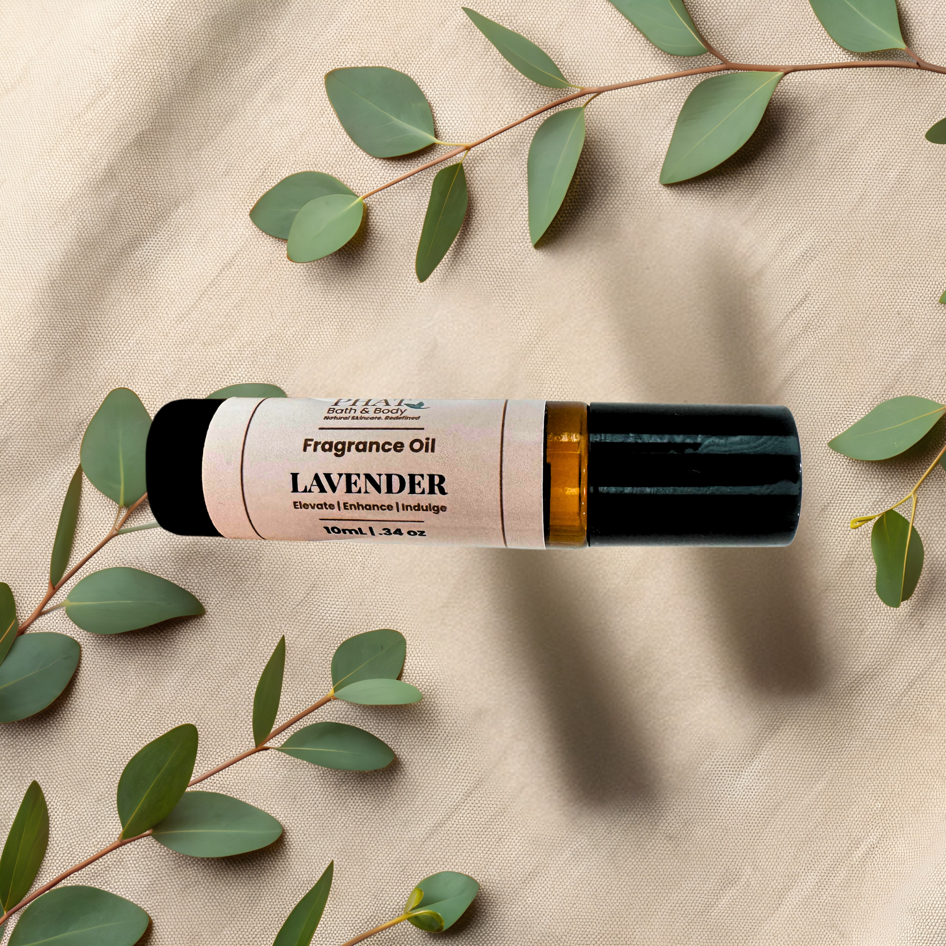 Lavender essential oil roller bottle with a black cap and a cream label, styled on a beige fabric background with green eucalyptus leaves.