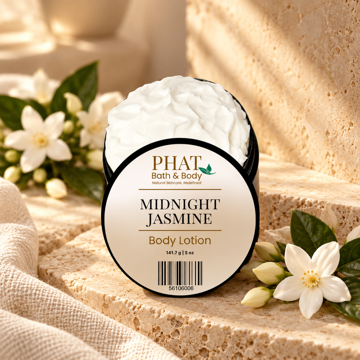 Phat Bath & Body Midnight Jasmine Body Lotion styled with lush jasmine blossoms, warm neutral stone, and soft floral accents.