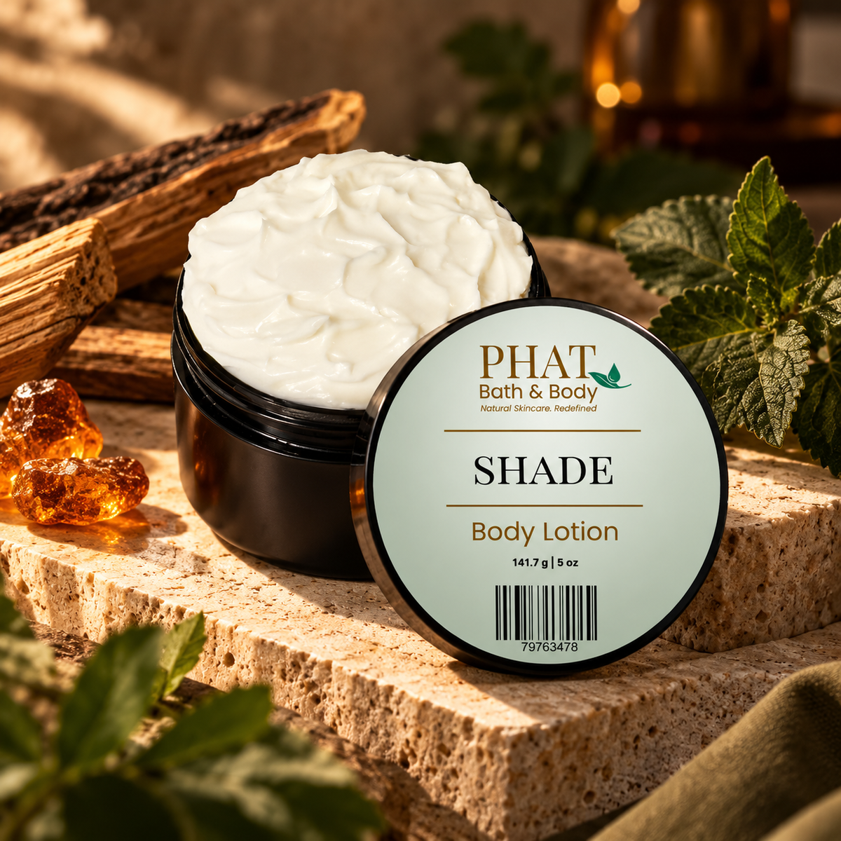 Phat Bath & Body Shade Men’s Body Lotion in a black 5 oz jar styled with warm woods, amber accents, greenery, and masculine fragrance notes.
