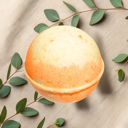 Bath bomb with green leaves on a beige fabric background