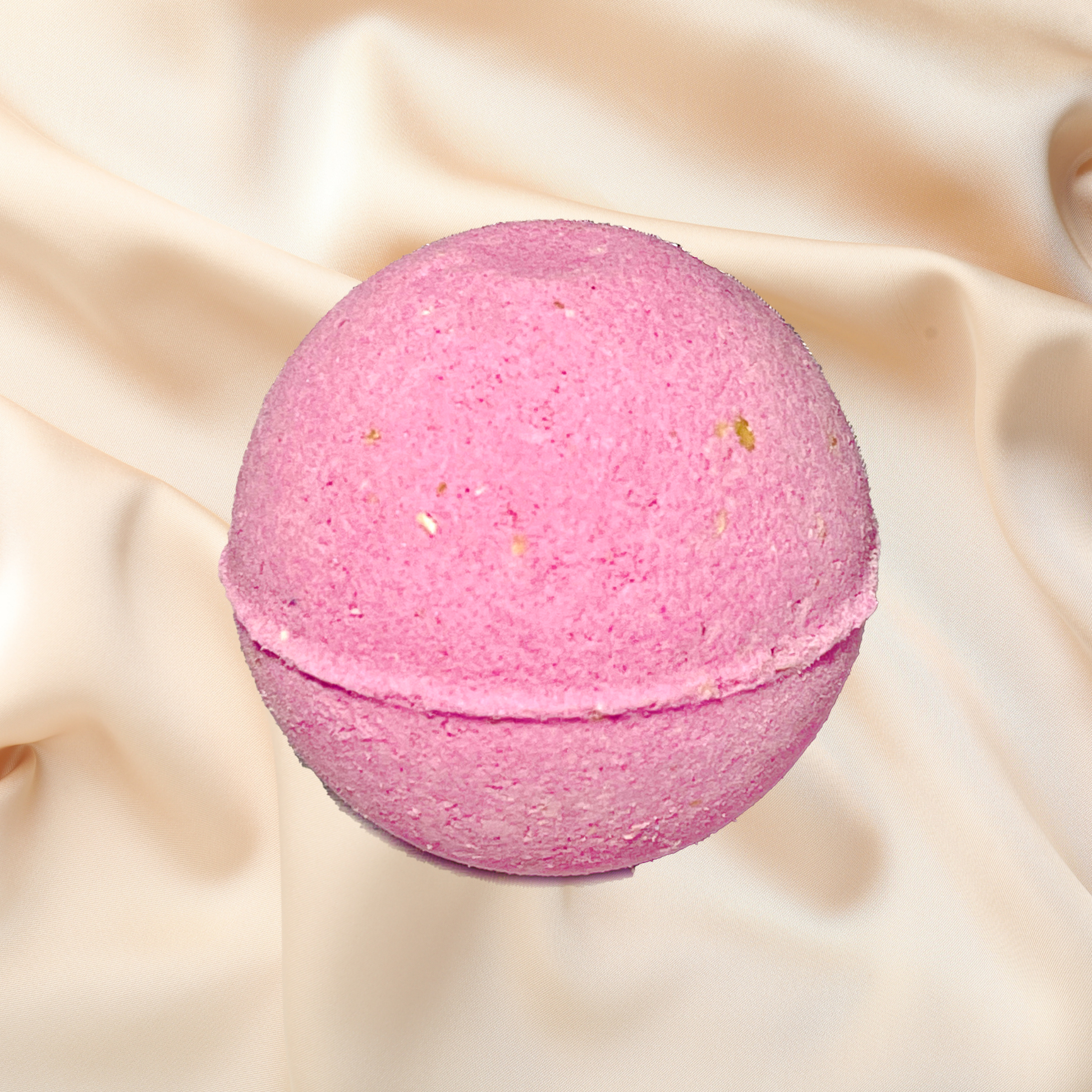Pink bath bomb on a beige fabric background