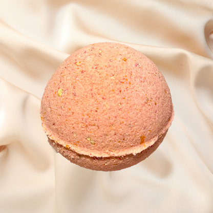 Pink bath bomb on a beige fabric background