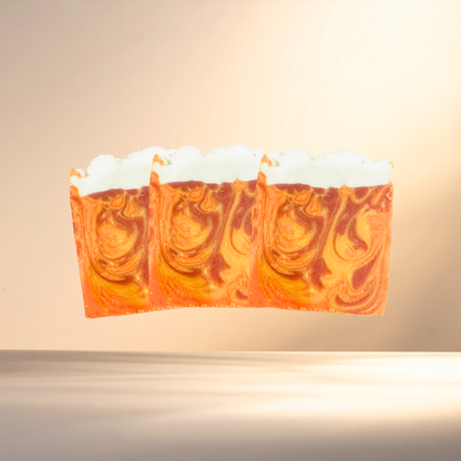 Bar of soap with orange and white swirl pattern on a beige background