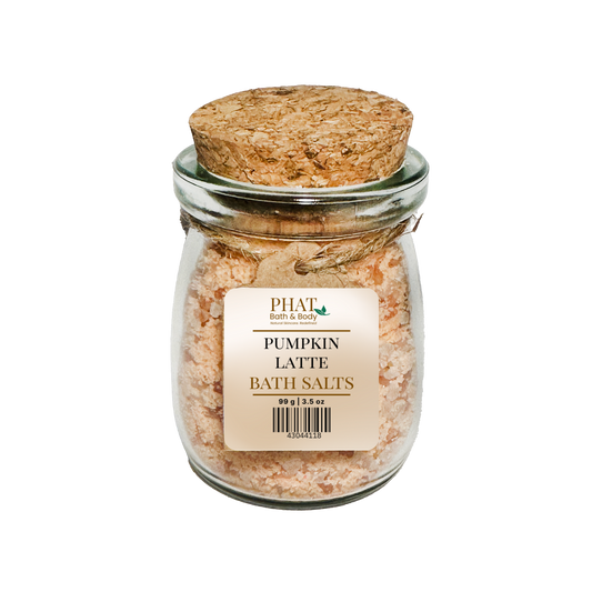 Jar of pumpkin latte bath salts with a cork lid on a white background