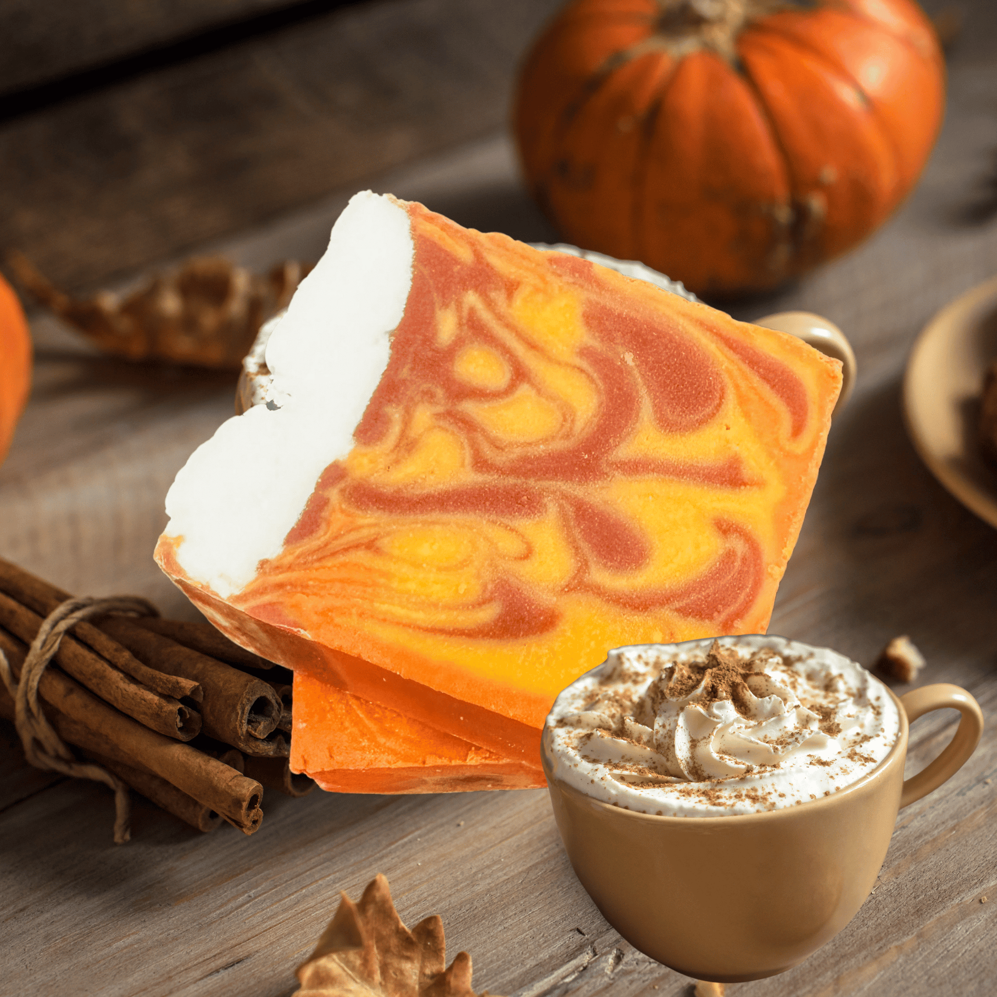 Pumpkin latte soap with a cup of pumpkin spice latte on a wooden surface.