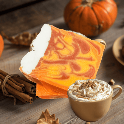 Pumpkin latte soap with a cup of pumpkin spice latte on a wooden surface.