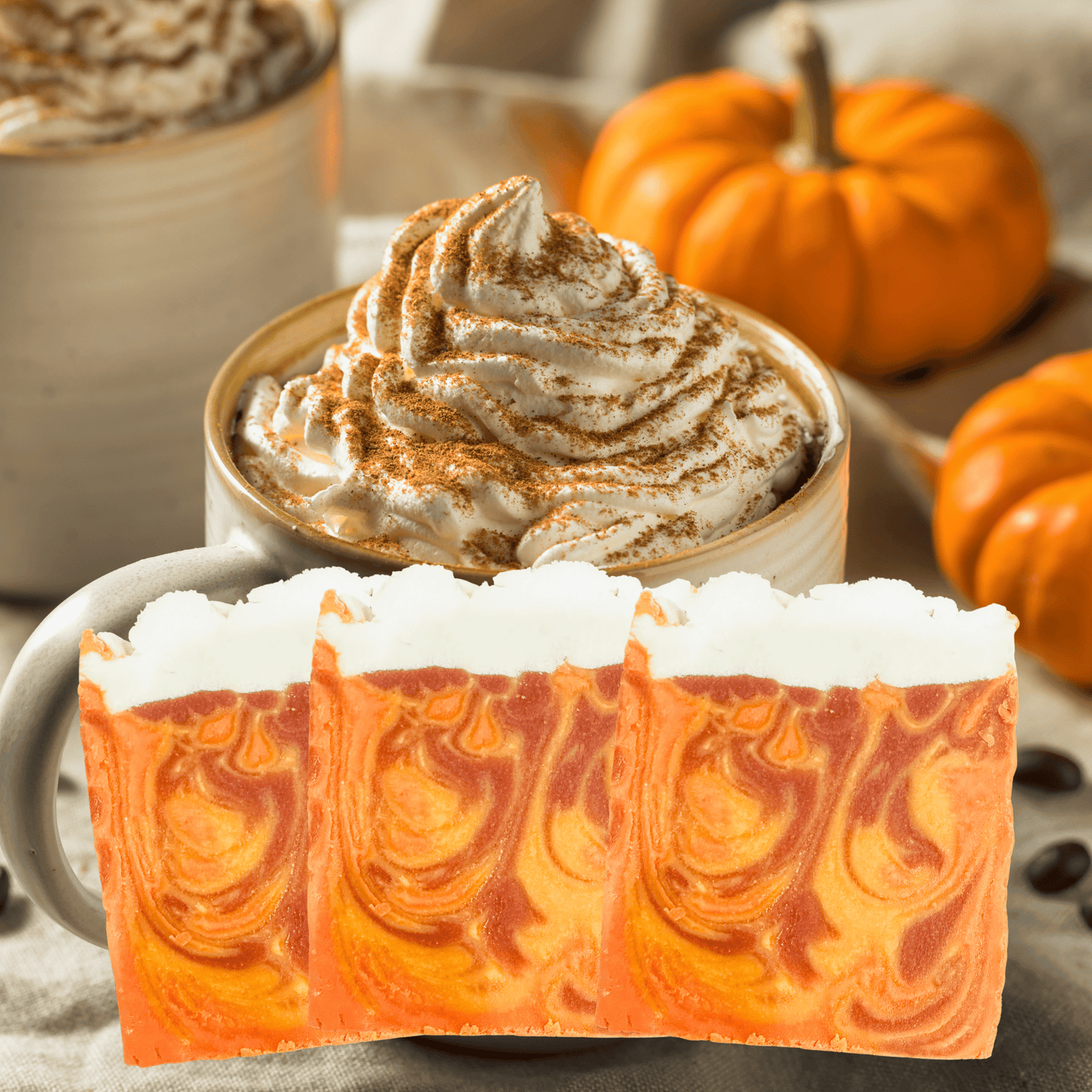 Pumpkin spice latte with whipped cream and a soap bar with pumpkin latte design.