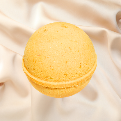 Yellow bath bomb on a beige fabric background