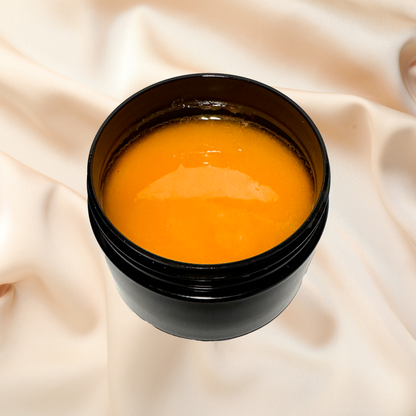 Black container with orange scrub on a beige fabric background