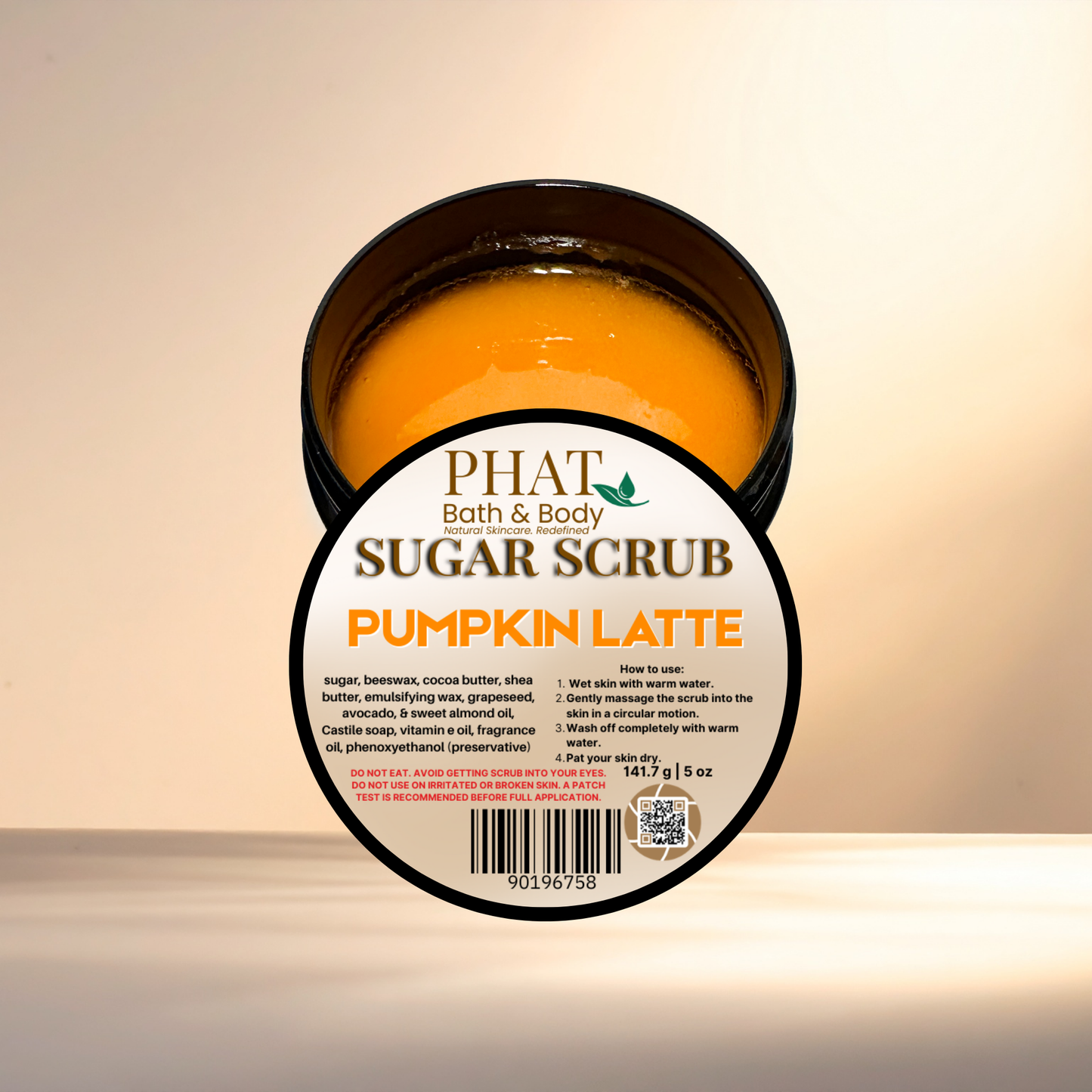 Jar of pumpkin latte sugar scrub with 'Phat Bath & Body' label on a beige background