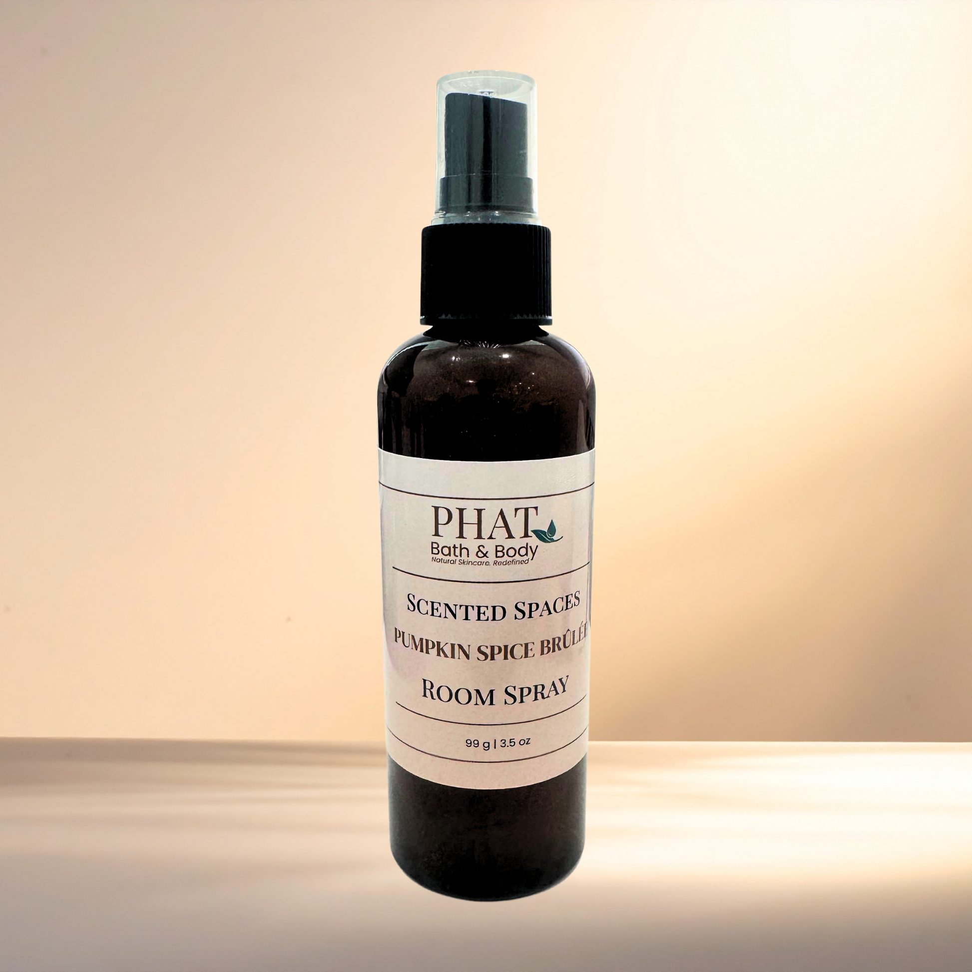 Room spray bottle labeled 'PHAT Bath & Body' on a gradient background