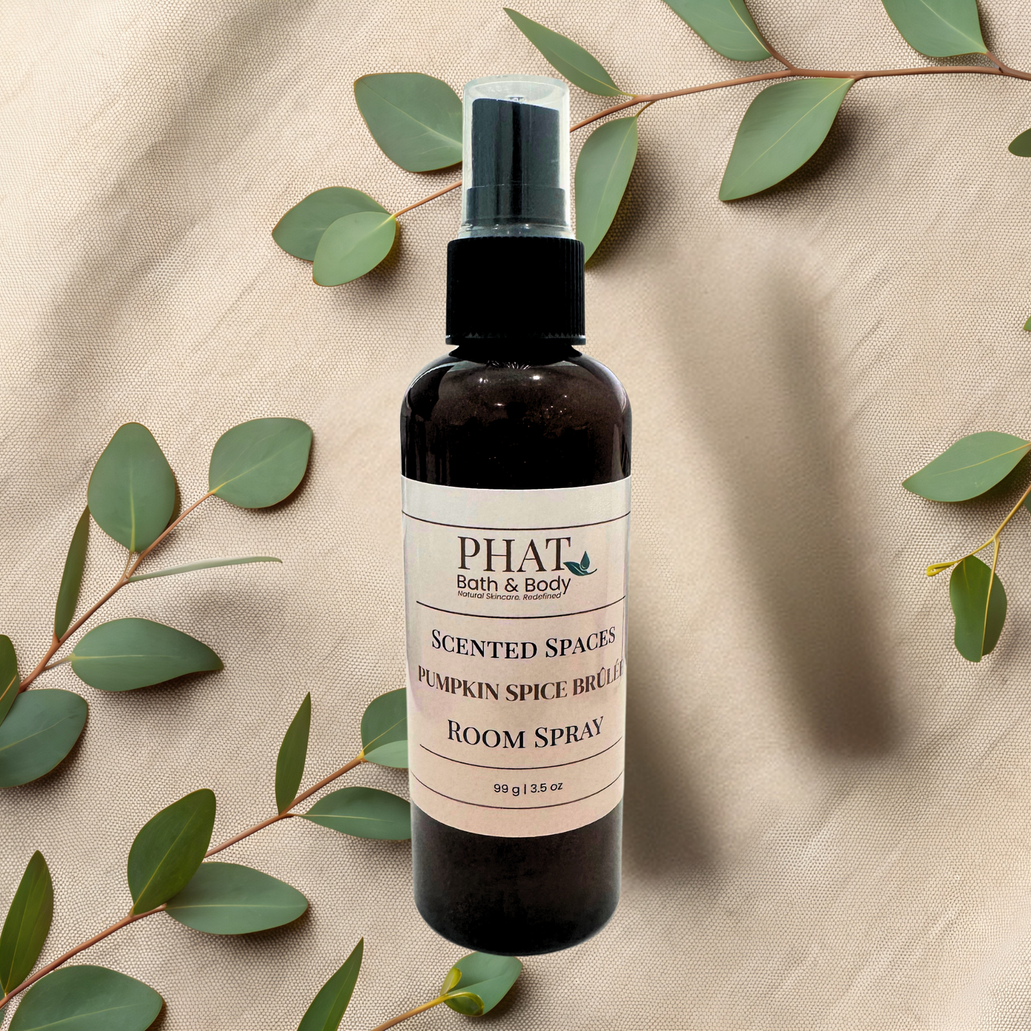 Room spray bottle with 'PHAT Bath & Body' label on a textured beige background