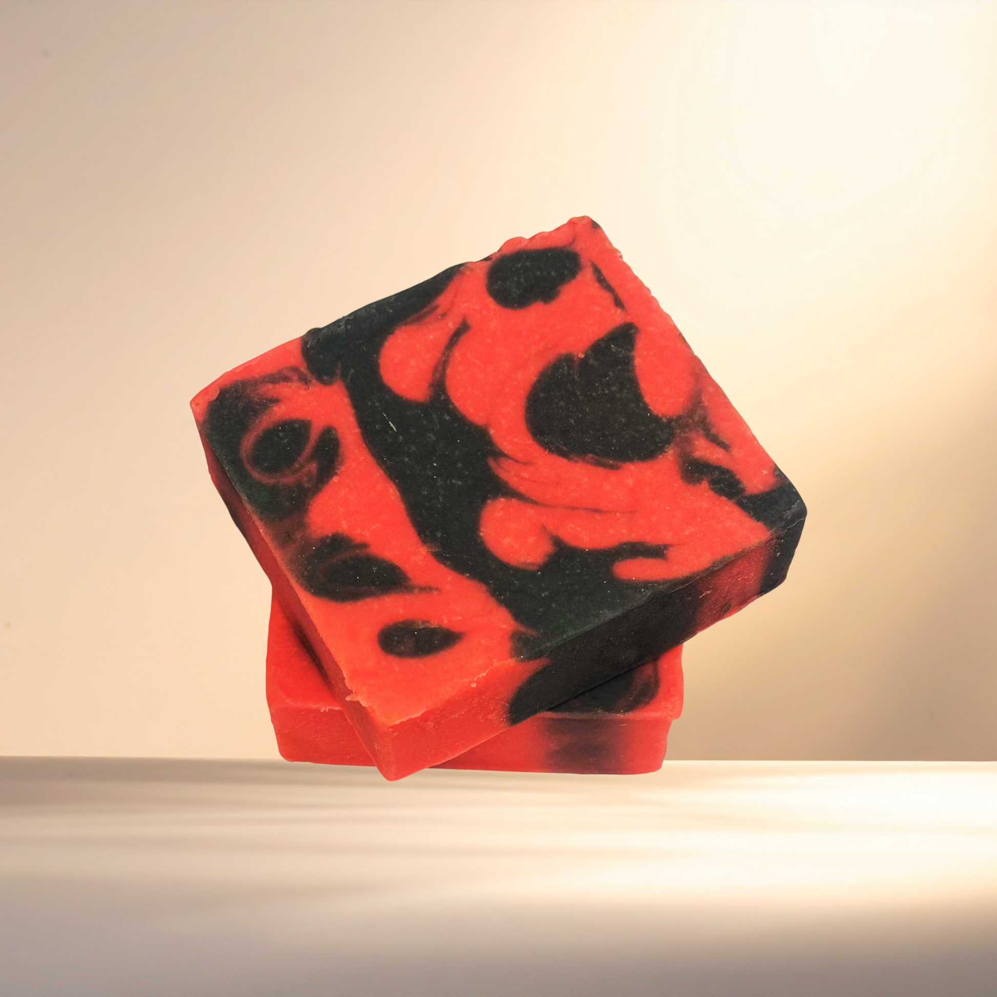 Red and black patterned soap bar on a neutral background