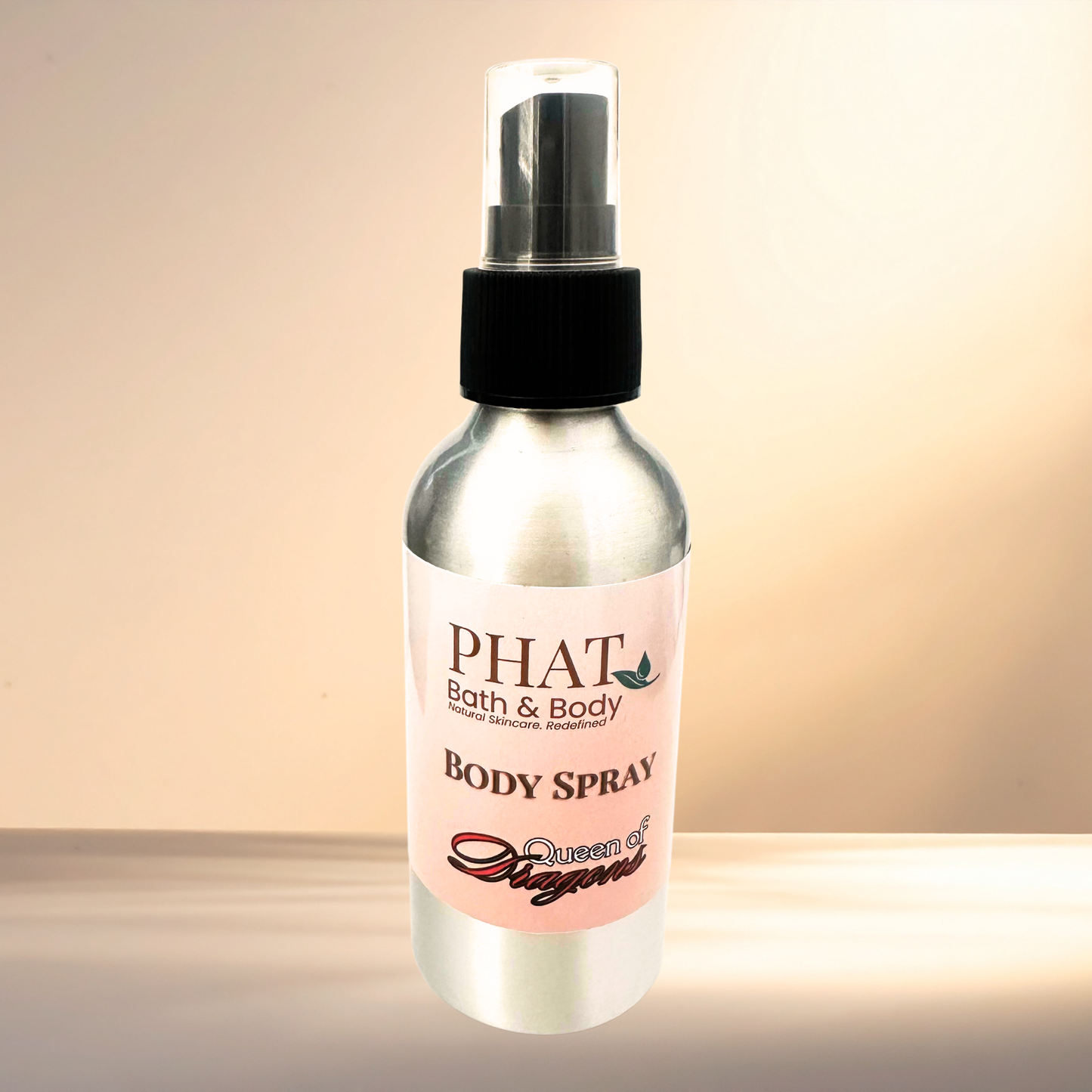 Body spray bottle with a pink label on a gradient background