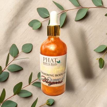 Bottle of PHAT Bath & Body Queen of Dragons body oil with dropper on a beige fabric background with green leaves.