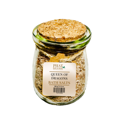 Jar of 'Queen of Dragons' bath salts with a cork lid on a white background