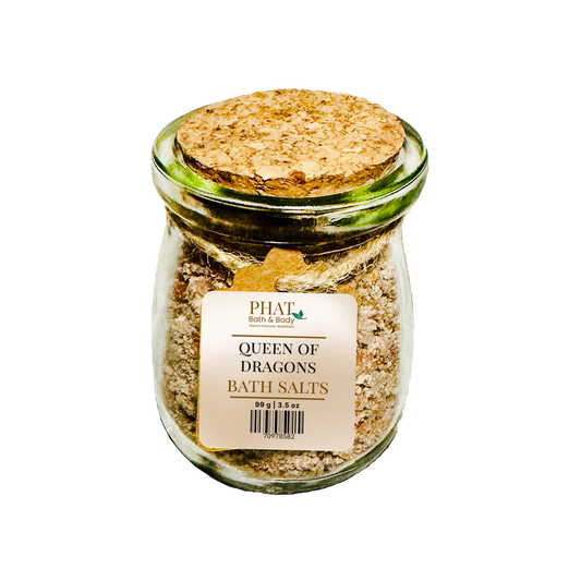 Jar of 'Queen of Dragons' bath salts with a cork lid on a white background