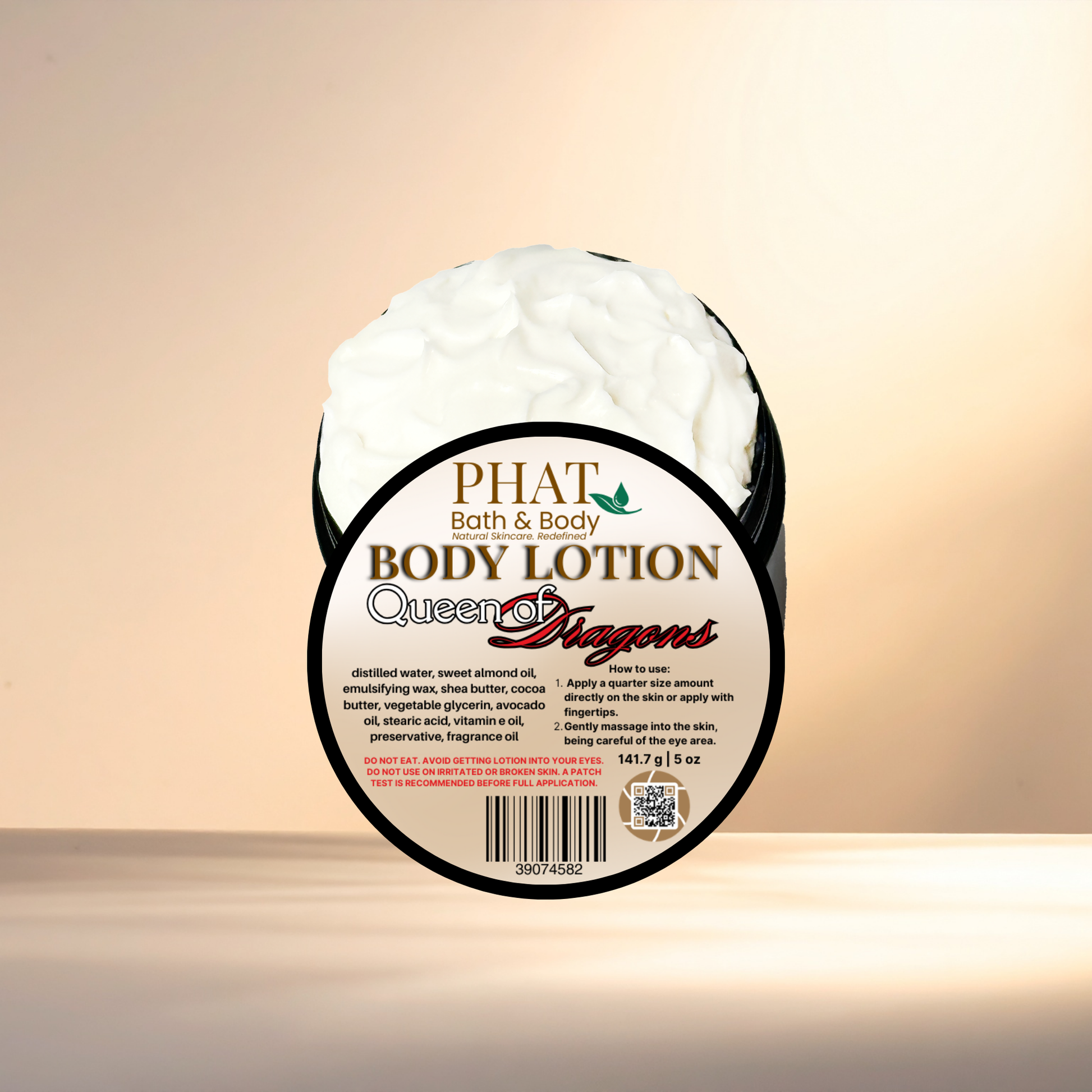 Body lotion container labeled 'Queen of Dragons' by Phat Bath & Body on a gradient background