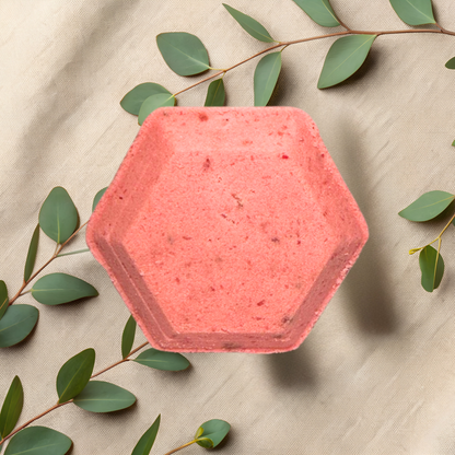 Hexagonal pink steamer with green leaves on a beige fabric background