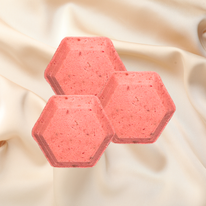 Hexagonal pink shower bombs on a beige fabric background