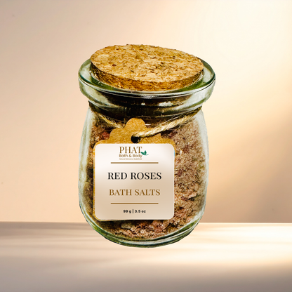Jar of 'Red Roses Bath Salts' with a cork lid on a gradient background