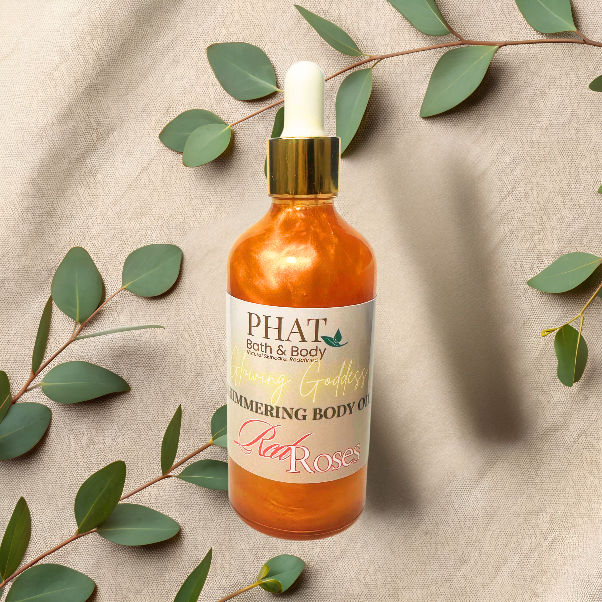 Bottle of 'PHAT Bath & Body' body oil with a dropper on a beige fabric background with green leaves.