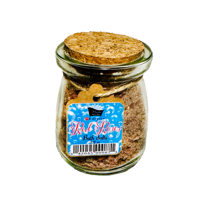 Jar of bath salts with a cork lid and 'Red Roses' label on a white background