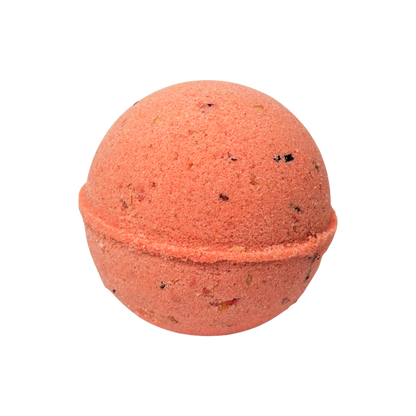 Red-colored bath bomb with specks on a white background
