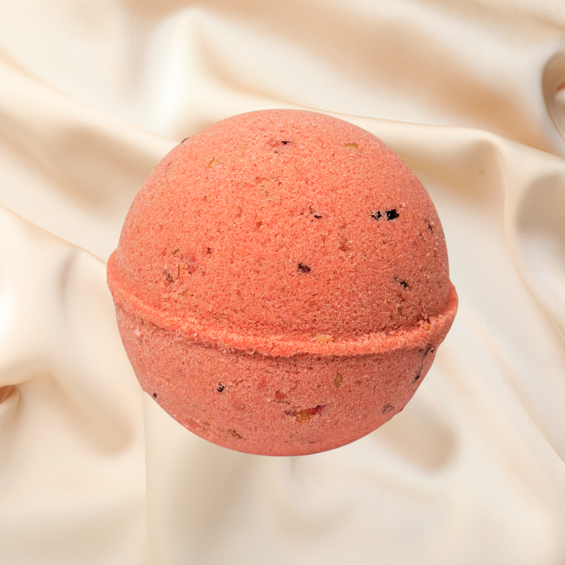 Red bath bomb on a beige fabric background