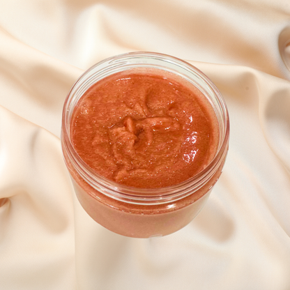 Jar of red scrub on a beige fabric background