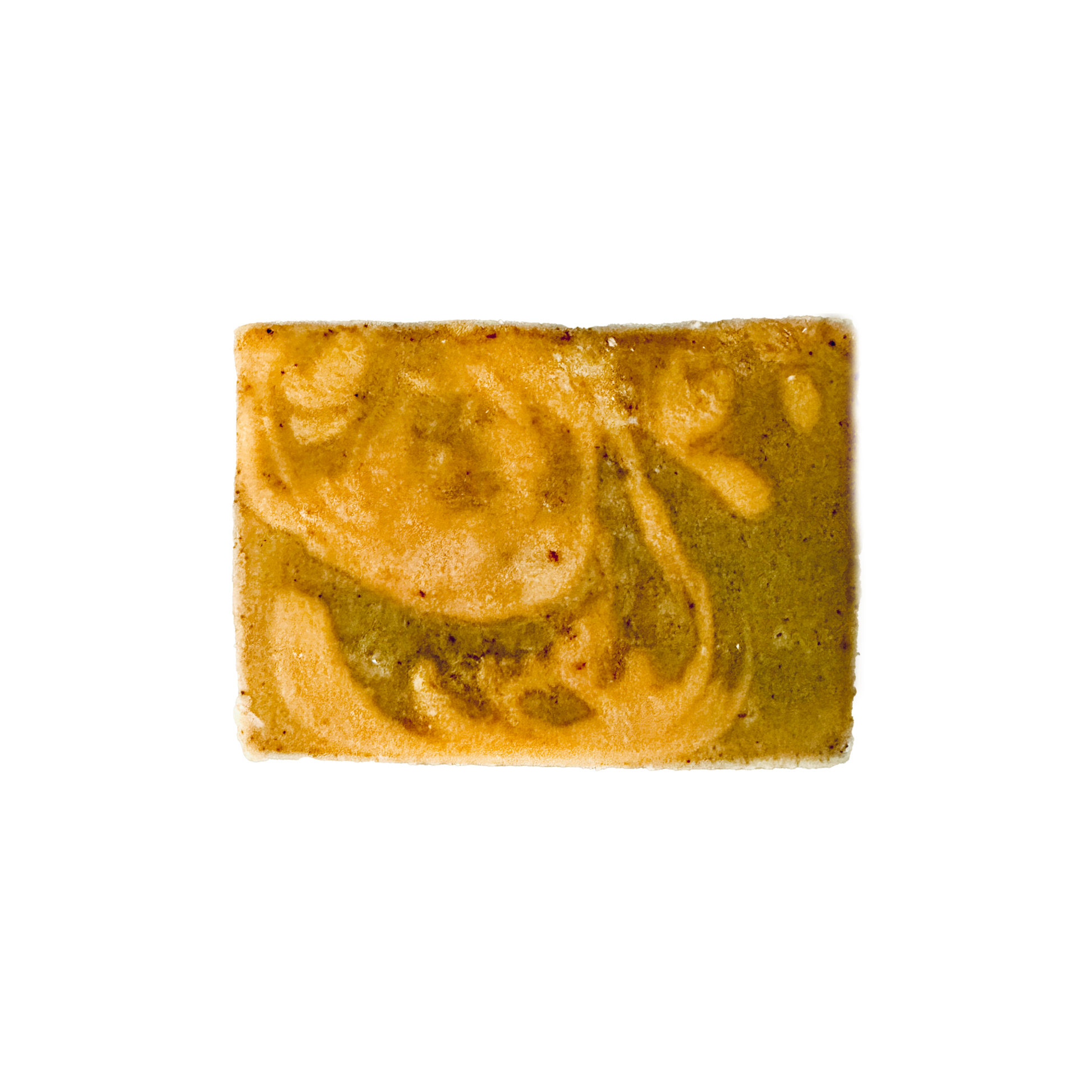 Rectangular bar of soap with green and beige swirls on a white background