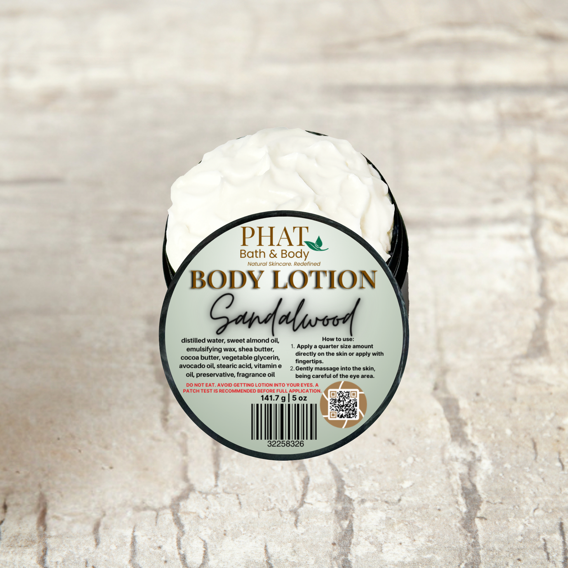 Body lotion container with 'Phat Bath & Body' label on a textured beige background