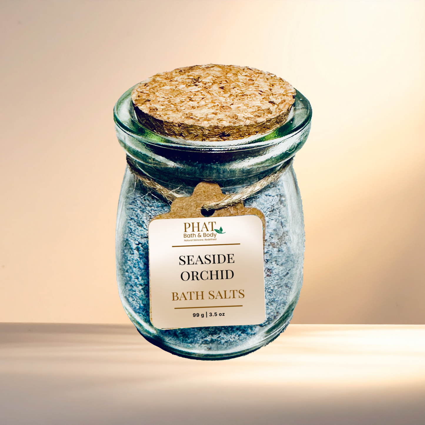 Jar of Seaside Orchid bath salts with a cork lid on a neutral background