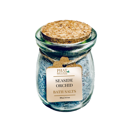 Jar of Seaside Orchid bath salts with cork lid on a white background