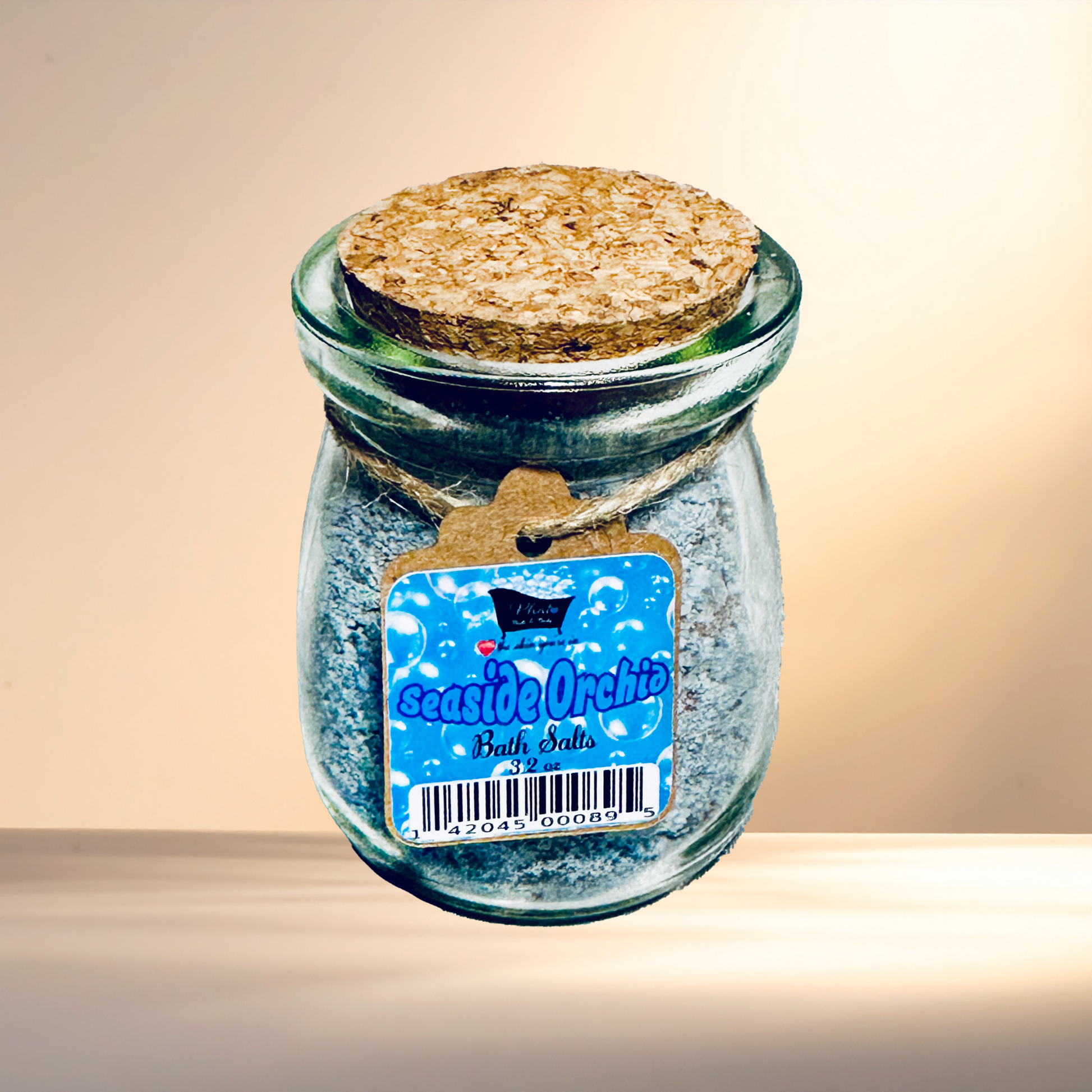 Jar of bath salts with a cork lid and label on a neutral background