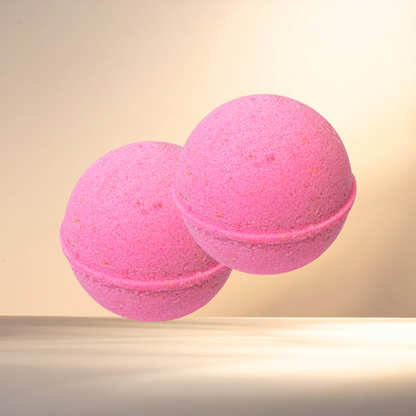 Two pink bath bombs on a beige background