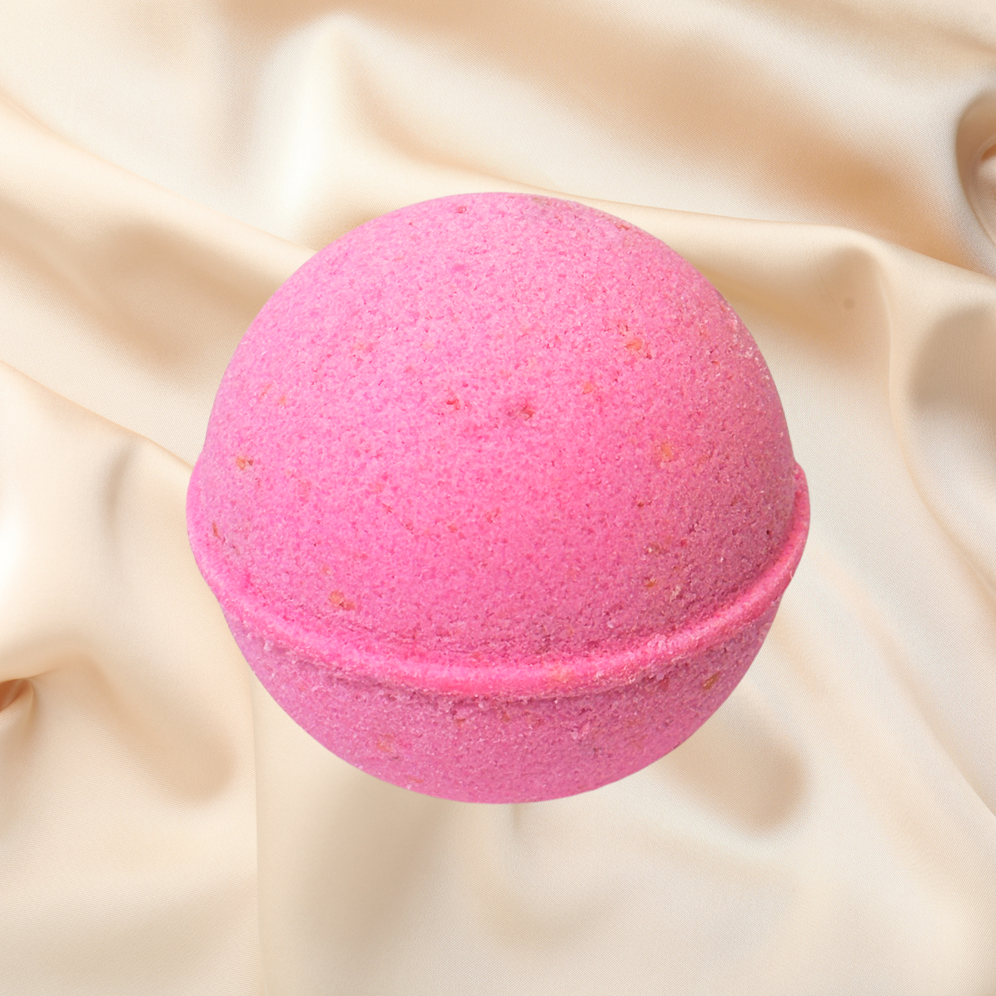 Pink bath bomb on a beige fabric background