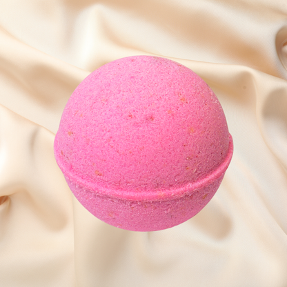 Pink bath bomb on a beige fabric background