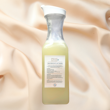 Bottle of laundry detergent on a soft fabric background