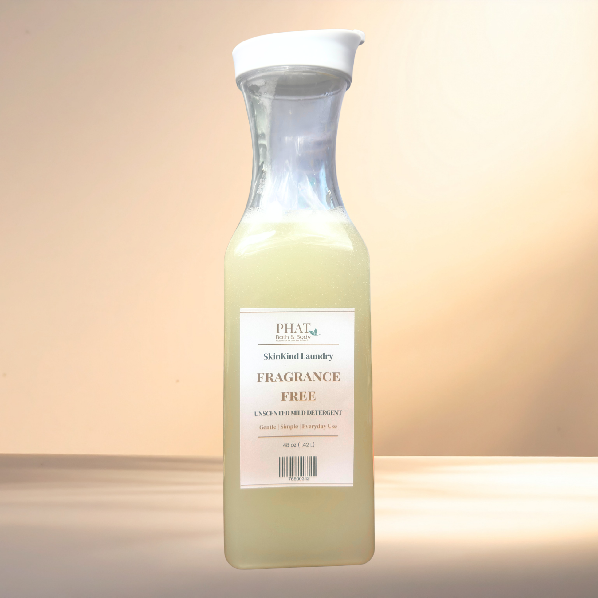Bottle of Phat Bath & Body. SkinKind laundry detergent on a gradient background