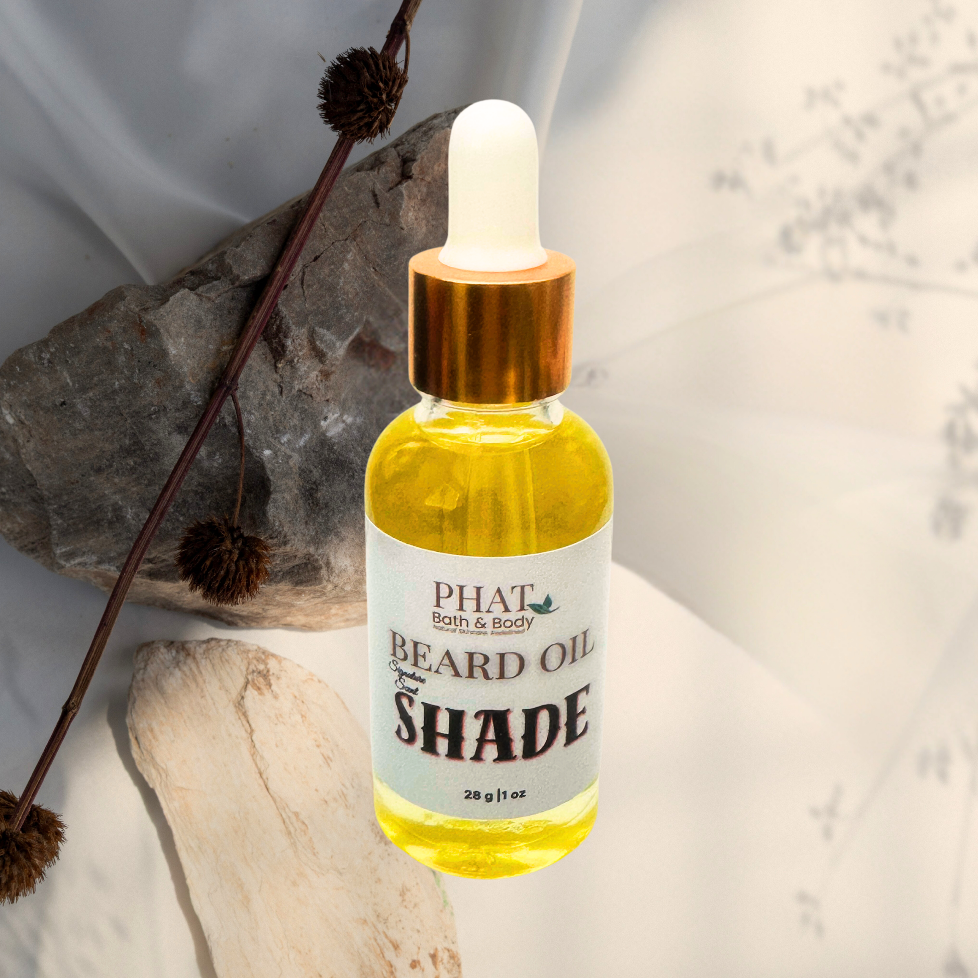 Bottle of Phat & Body Beard Oil on a textured surface with a natural background
