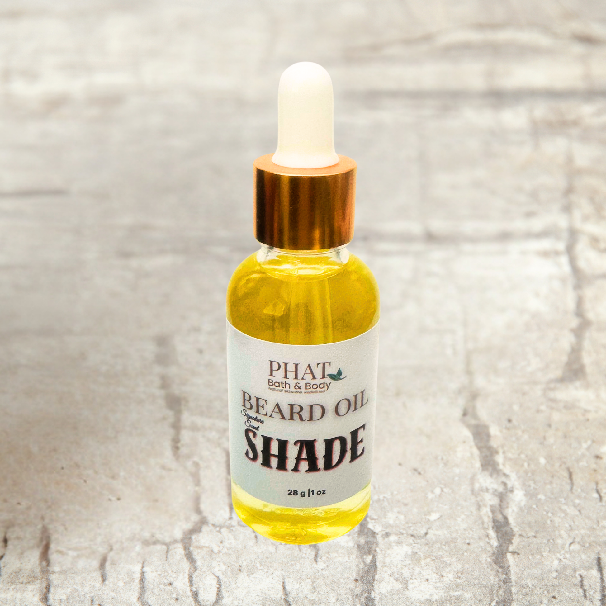 Bottle of Phat Bath & Body Beard Oil on a textured surface