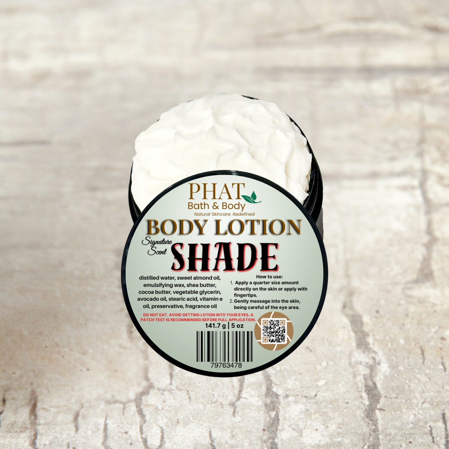 Body lotion container with 'Phat Bath & Body' label on a textured beige background