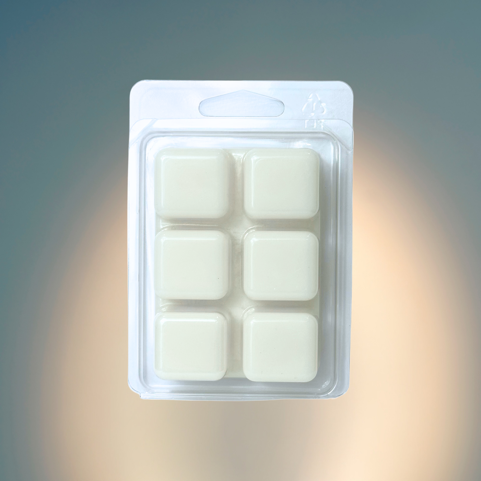 Pack of six white wax melts in a clear plastic packaging on a gradient background