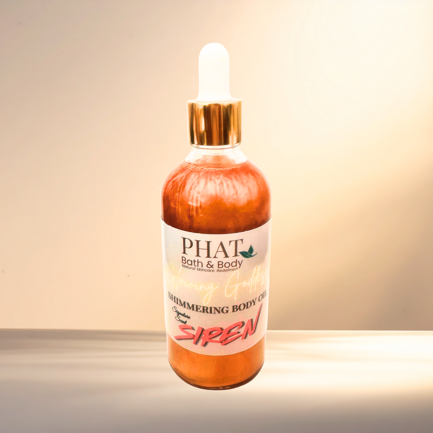 Bottle of 'PHAT Bath & Body' shimmering body oil with a gold dropper on a gradient background