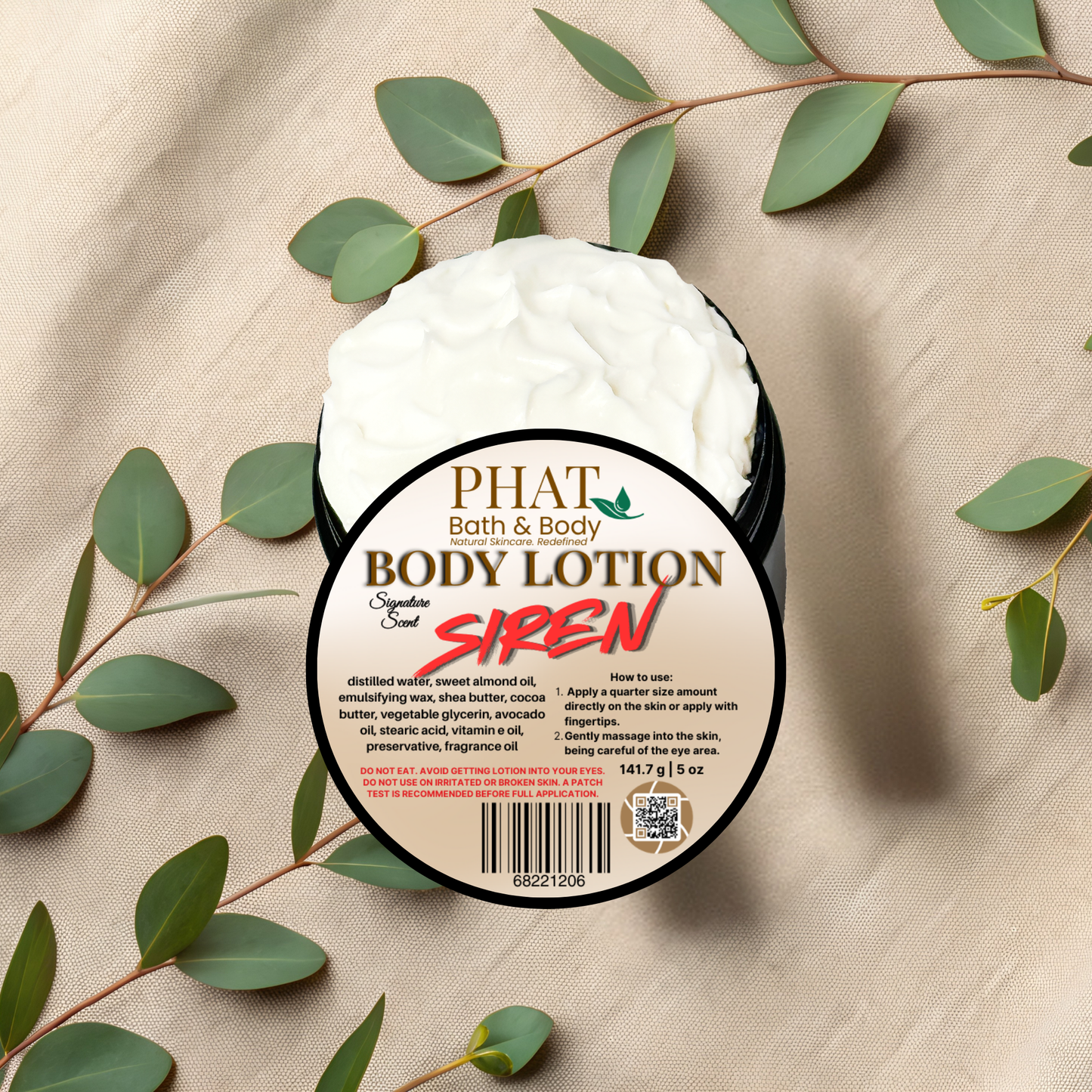 Body lotion container labeled 'PHAT Bath & Body' with green leaves on a beige fabric background