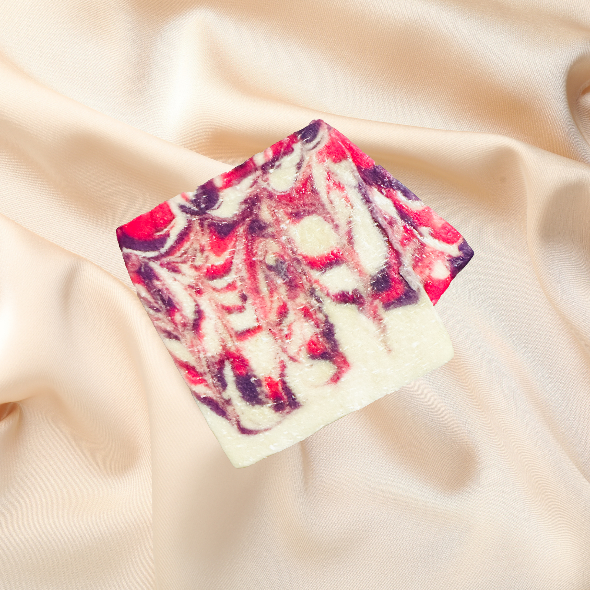 Colorful soap bar with a marbled pattern on a beige fabric background