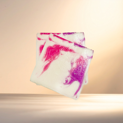 Two colorful soap bars with pink and purple swirls on a beige background