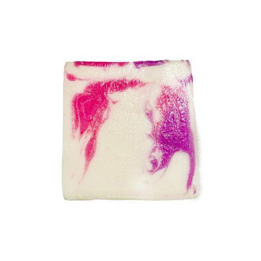Square bar of soap with pink and purple swirls on a white background