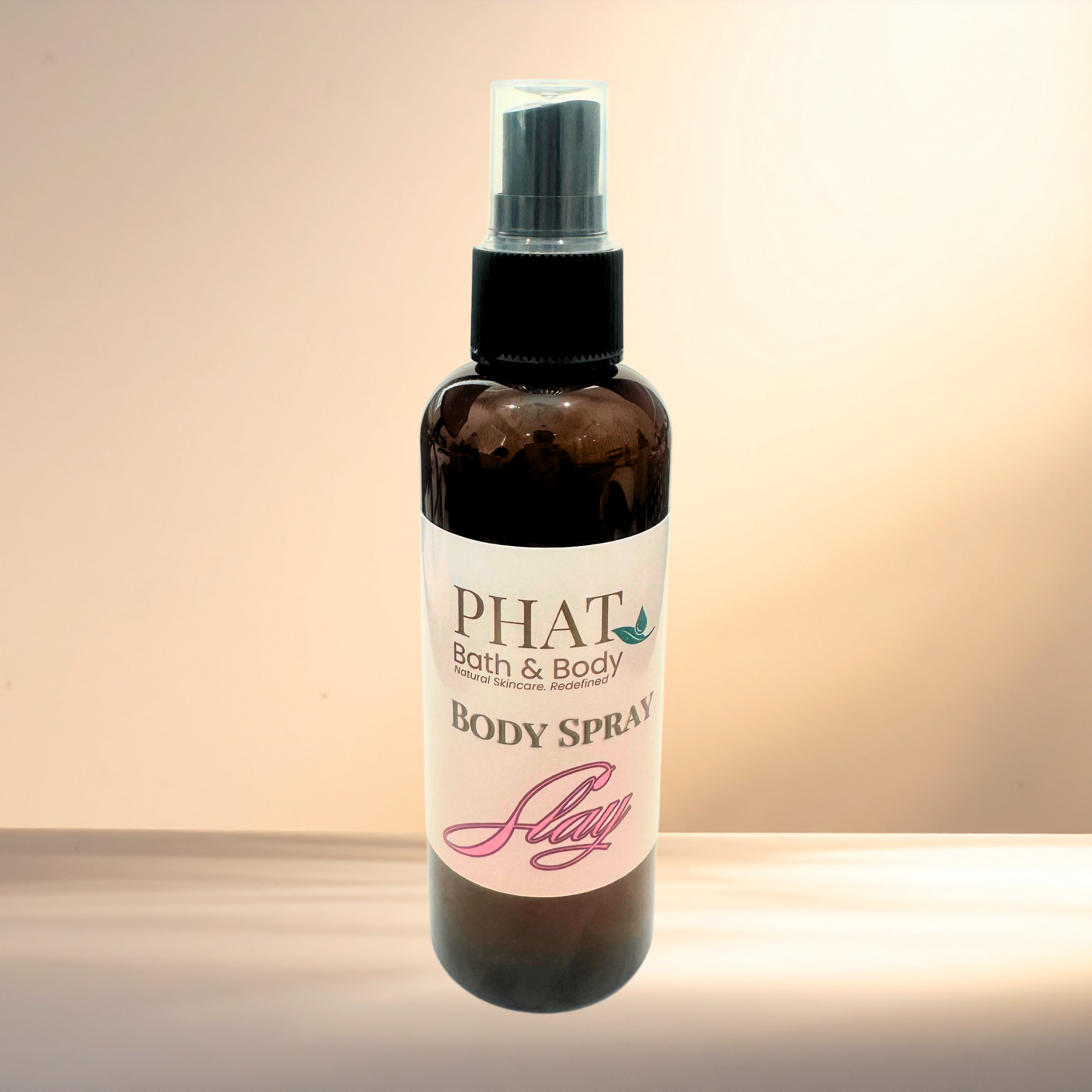 Body spray bottle with 'PHAT Bath & Body' label on a gradient background